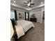 Spacious bedroom with a ceiling fan, tray ceilings, and a view into the ensuite bathroom at 3006 Fairway Dr, Villa Rica, GA 30180