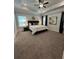 Serene main bedroom with a tray ceiling, carpeted floors, and abundant natural light at 3006 Fairway Dr, Villa Rica, GA 30180