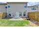 Backyard patio with seating area, grassy lawn, and privacy fence, creating a cozy outdoor retreat at 3123 Cross Creek Dr, Cumming, GA 30040