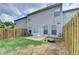 Patio area with seating and a grassy lawn enclosed by a wooden privacy fence, perfect for outdoor living at 3123 Cross Creek Dr, Cumming, GA 30040