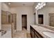 Well-lit bathroom showcasing a glass-enclosed shower, soaking tub, and double granite vanity for convenience at 3123 Cross Creek Dr, Cumming, GA 30040