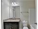 A bathroom with vanity, sink, toilet, and a mirror with granite countertop at 3123 Cross Creek Dr, Cumming, GA 30040