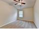 A carpeted bedroom featuring a ceiling fan and a window that provides natural light at 3123 Cross Creek Dr, Cumming, GA 30040