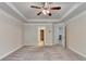 Large bedroom with multiple doors, plush carpeting, and ceiling fan at 3123 Cross Creek Dr, Cumming, GA 30040