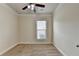 A carpeted bedroom featuring a ceiling fan and a window that provides natural light at 3123 Cross Creek Dr, Cumming, GA 30040