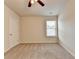 A simply designed bedroom with carpeted flooring, ceiling fan, and a window at 3123 Cross Creek Dr, Cumming, GA 30040