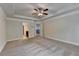 Open Primary bedroom boasts plush carpet, modern ceiling fan and an adjacent doorway to the luxurious bathroom at 3123 Cross Creek Dr, Cumming, GA 30040