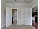 Bedroom featuring carpet, ceiling fan, closet, access to bath, and view to kitchen at 3123 Cross Creek Dr, Cumming, GA 30040