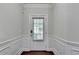 Welcoming entryway featuring classic wainscoting, neutral paint, and wood flooring at 3123 Cross Creek Dr, Cumming, GA 30040