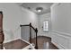 Elegant entryway with a staircase, wainscoting, dark wood floors, and a front door at 3123 Cross Creek Dr, Cumming, GA 30040