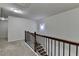 Neutral hallway with dark wood and iron railing and neutral carpet throughout at 3123 Cross Creek Dr, Cumming, GA 30040