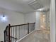 Upstairs hallway with dark wood and iron railing and neutral carpet throughout at 3123 Cross Creek Dr, Cumming, GA 30040