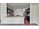 A full kitchen view featuring granite countertops, dark cabinetry, stainless steel appliances, and hardwood floors at 3123 Cross Creek Dr, Cumming, GA 30040