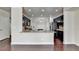 Open kitchen with granite counters, stainless appliances, dark cabinets, tile backsplash and hardwood floors at 3123 Cross Creek Dr, Cumming, GA 30040
