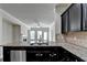 Modern kitchen features granite countertops, stainless steel appliances, dark cabinets, and an eat-in bar at 3123 Cross Creek Dr, Cumming, GA 30040