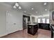 Modern kitchen featuring stainless steel appliances, dark cabinets, and a central island at 3123 Cross Creek Dr, Cumming, GA 30040