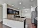 A kitchen view with granite countertops, stainless steel appliances, dark cabinetry, and hardwood flooring at 3123 Cross Creek Dr, Cumming, GA 30040