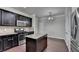 A kitchen showcasing an island, stainless steel appliances, dark cabinets, and hardwood flooring at 3123 Cross Creek Dr, Cumming, GA 30040