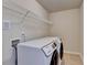 Well-lit laundry room with modern washer and dryer units and wire shelving at 3123 Cross Creek Dr, Cumming, GA 30040