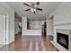 Bright, open floor plan with hardwood floors and a fireplace connects to the kitchen and hallway at 3123 Cross Creek Dr, Cumming, GA 30040