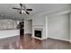 Beautiful living room showcasing fireplace, hardwood floors, and open to kitchen at 3123 Cross Creek Dr, Cumming, GA 30040