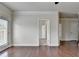 A transition space with hardwood floors featuring doorways leading to other carpeted and tiled rooms at 3123 Cross Creek Dr, Cumming, GA 30040