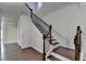 Elegant staircase featuring dark wood stairs and banister, and neutral walls at 3123 Cross Creek Dr, Cumming, GA 30040