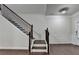 Stylish staircase with dark wood steps, black wrought iron spindles, and white risers at 3123 Cross Creek Dr, Cumming, GA 30040
