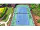 Aerial view of a community tennis court surrounded by lush landscaping and black fencing at 3123 Cross Creek Dr, Cumming, GA 30040