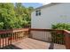 Back deck surrounded by lush trees, offering a private outdoor space for relaxation and entertainment at 152 Stoneforest Dr, Woodstock, GA 30189