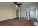 Finished basement features a ceiling fan and multiple doorways, creating a versatile living space at 152 Stoneforest Dr, Woodstock, GA 30189