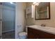 This bathroom features a single sink vanity with a walk-in closet and a mirror at 152 Stoneforest Dr, Woodstock, GA 30189