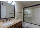 This bathroom features a vanity with granite countertop and a shower with glass doors at 152 Stoneforest Dr, Woodstock, GA 30189