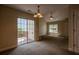 Dining area with sliding glass doors to the deck, adjacent to the living room with fan at 152 Stoneforest Dr, Woodstock, GA 30189