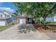 Charming brick home with a one-car garage and driveway, complemented by mature landscaping at 152 Stoneforest Dr, Woodstock, GA 30189