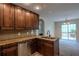 Modern kitchen featuring stainless steel appliances, granite countertops, and dark wood cabinetry at 152 Stoneforest Dr, Woodstock, GA 30189