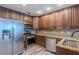 Modern kitchen featuring stainless steel appliances, granite countertops, and dark wood cabinetry at 152 Stoneforest Dr, Woodstock, GA 30189