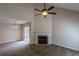 Bright living room featuring a fireplace, vaulted ceilings with fan, and access to the outdoor deck at 152 Stoneforest Dr, Woodstock, GA 30189