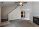 Bright living room featuring a fireplace, vaulted ceilings with fan, and access to the outdoor deck at 152 Stoneforest Dr, Woodstock, GA 30189