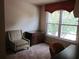 Cozy bedroom featuring natural light and comfortable furniture at 1527 Princeton Ave, College Park, GA 30337