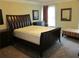 Comfortable main bedroom featuring dark wood furniture and a window for natural light at 1527 Princeton Ave, College Park, GA 30337