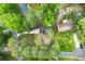 Aerial view of a home with a driveway, yard, and mature trees at 256 Grist Mill Ln, Lawrenceville, GA 30046