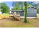 Exterior view of a home with a deck and stairs in a spacious backyard at 256 Grist Mill Ln, Lawrenceville, GA 30046