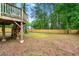 Fenced backyard with an elevated deck and mature trees at 256 Grist Mill Ln, Lawrenceville, GA 30046