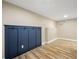 Finished basement area with wood-look flooring and built-in coat rack at 256 Grist Mill Ln, Lawrenceville, GA 30046