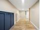 Finished basement hallway with wood-look flooring and built-in coat rack at 256 Grist Mill Ln, Lawrenceville, GA 30046