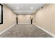 The basement features neutral walls, carpeted flooring, and modern lighting for a flexible living space at 256 Grist Mill Ln, Lawrenceville, GA 30046