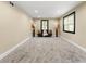Open basement features a sofa, natural light from two windows, and recessed lighting at 256 Grist Mill Ln, Lawrenceville, GA 30046