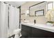 This bathroom features modern vanity with an undermount sink, large mirror, and shower with curtain at 256 Grist Mill Ln, Lawrenceville, GA 30046