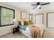This bedroom features a ceiling fan, a window, and two closets for ample storage at 256 Grist Mill Ln, Lawrenceville, GA 30046